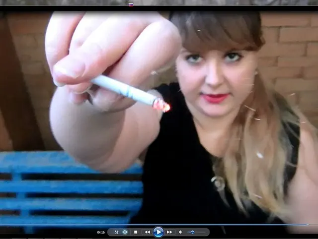 Girl with red lips sweet smokes